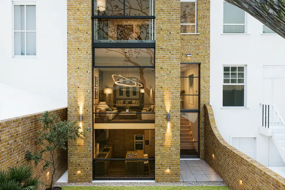Rear of a Victorian townhouse in brick, with a tall glazed extension opening to the garden
