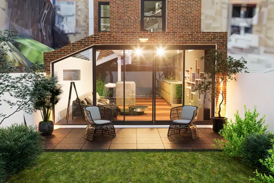 3D view of a lit garden room with sofa, floor lamp and kitchen beyond, seen from the terrace at dusk